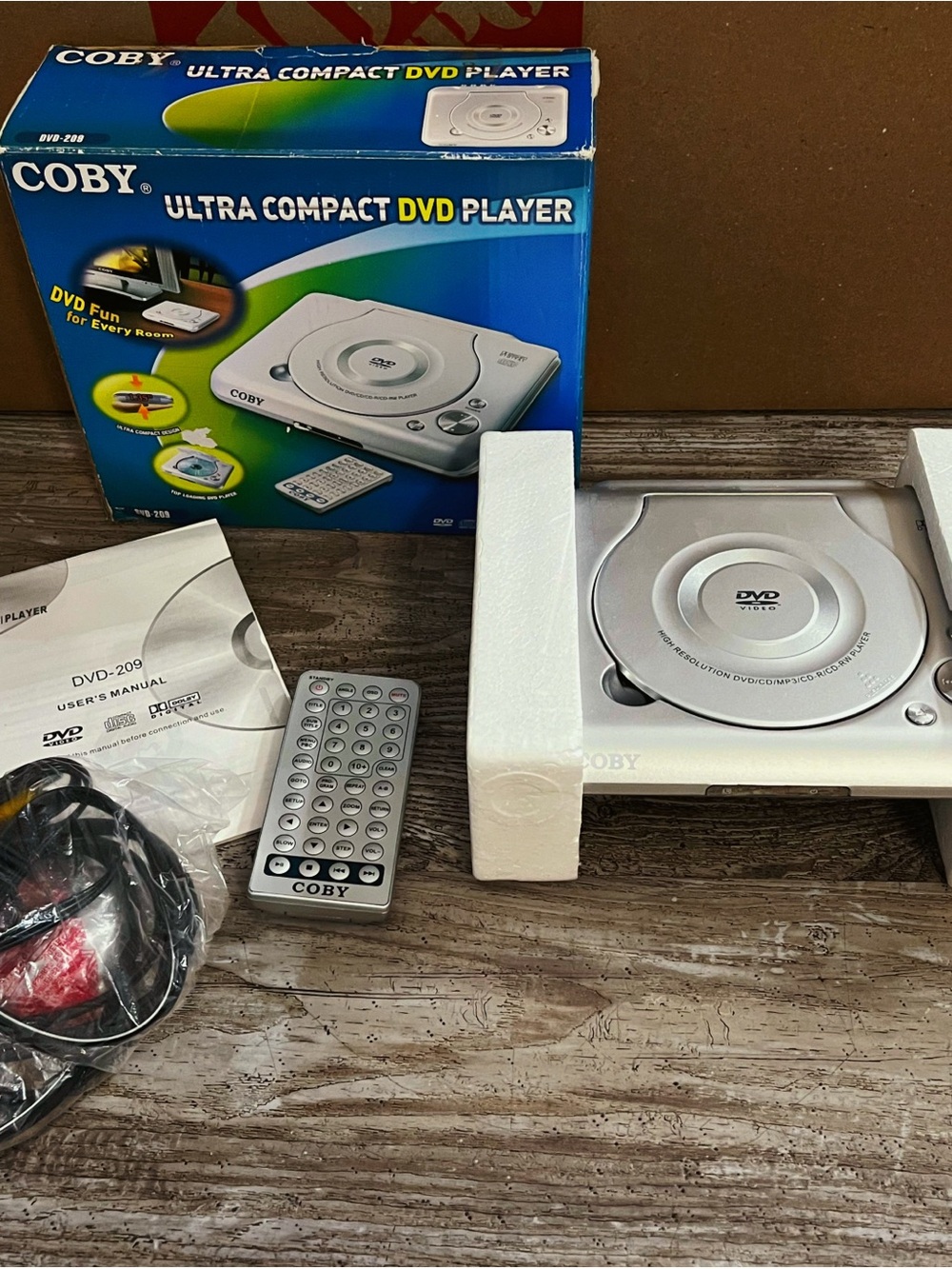 New In Box Coby DVD-209 Ultra Compact DVD Player With Remote & Manual
